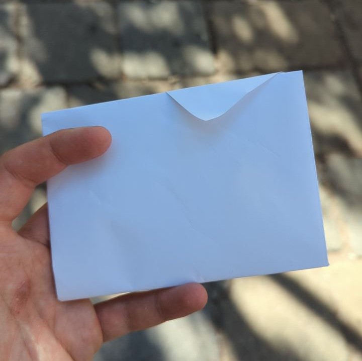 picture of hand holding a paper envelope