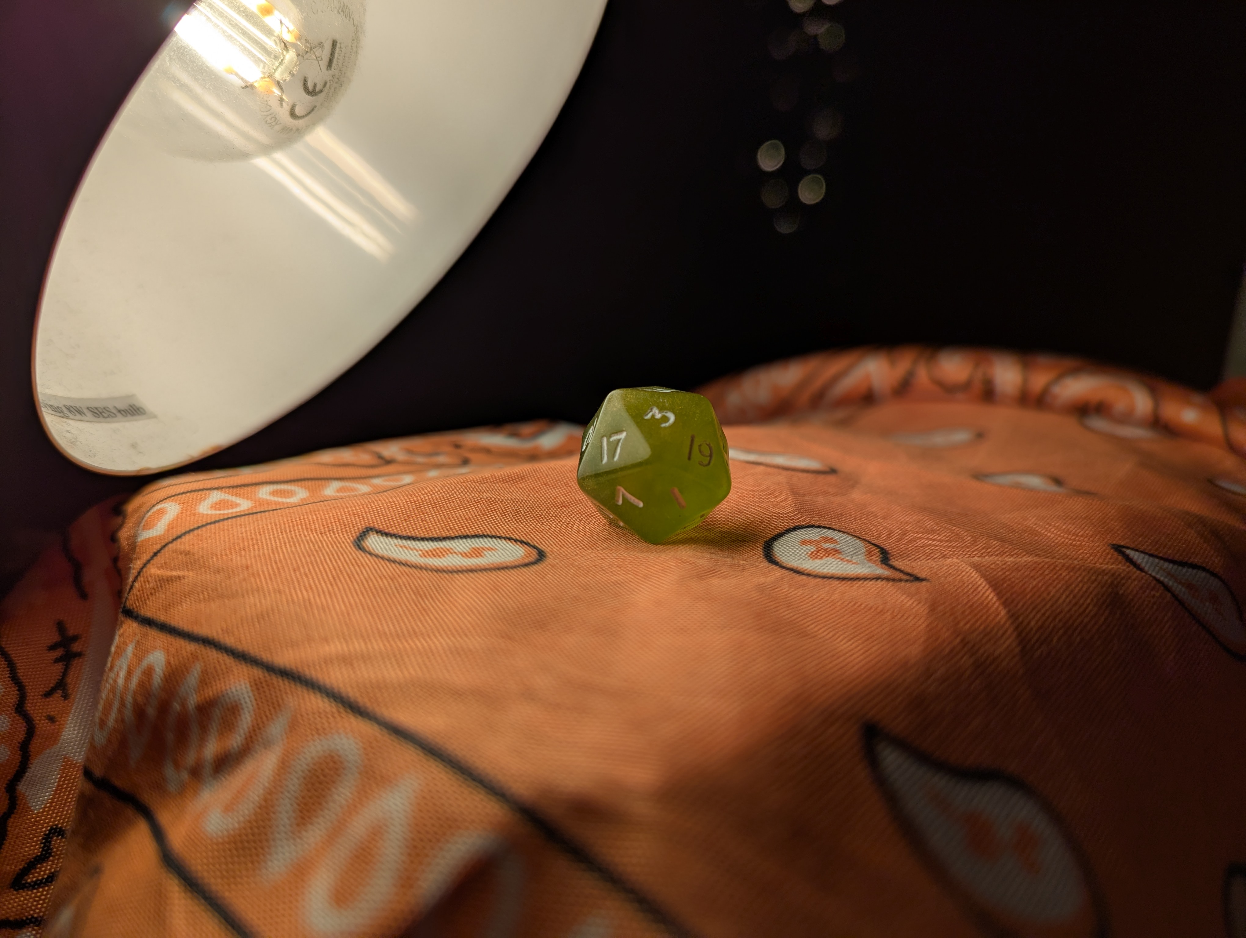 picture of green dice under a lamp
